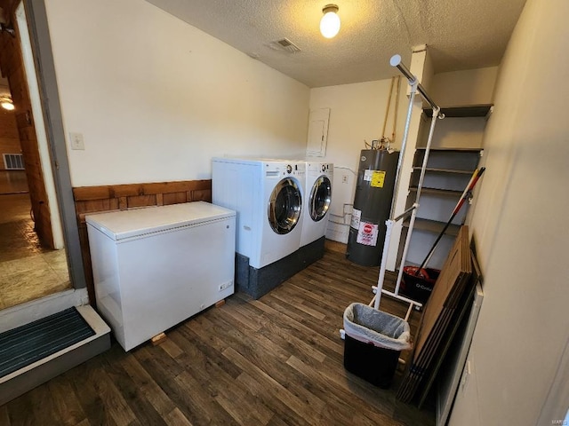 laundry area with laundry area, dark wood-style floors, washing machine and clothes dryer, a textured ceiling, and water heater