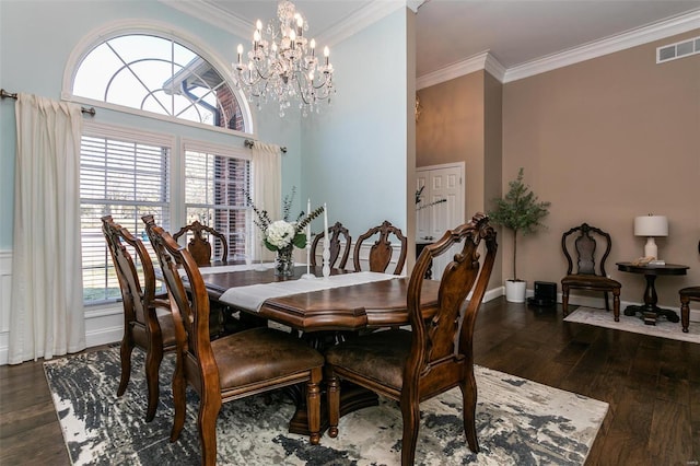 dining room with dark wood-style flooring, crown molding, visible vents, a chandelier, and baseboards