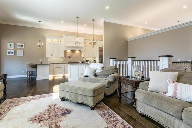 living room featuring crown molding, dark wood finished floors, and a notable chandelier