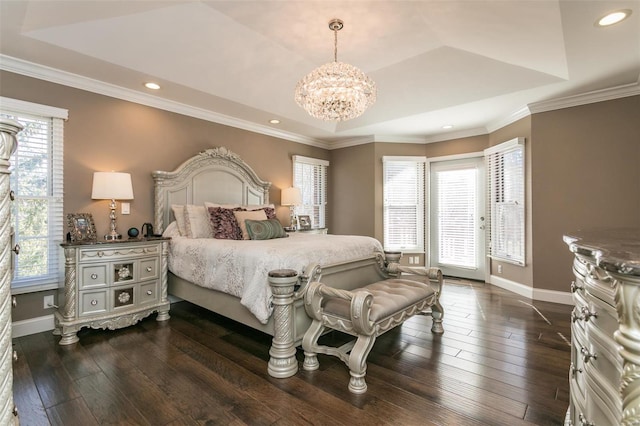 bedroom featuring a notable chandelier, dark wood-style flooring, baseboards, a tray ceiling, and crown molding