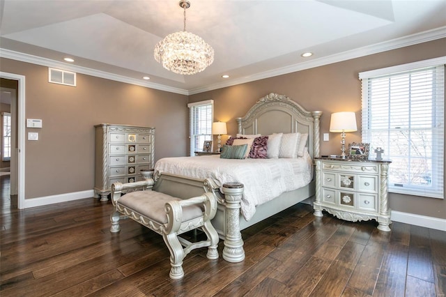 bedroom featuring visible vents, baseboards, a tray ceiling, dark wood finished floors, and crown molding