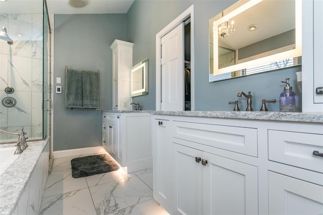 full bathroom with marble finish floor, a marble finish shower, a bathing tub, vanity, and baseboards