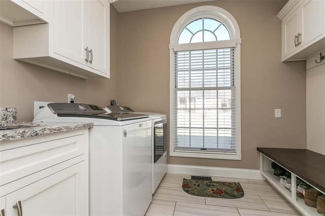 laundry room with visible vents, cabinet space, washer and clothes dryer, and baseboards