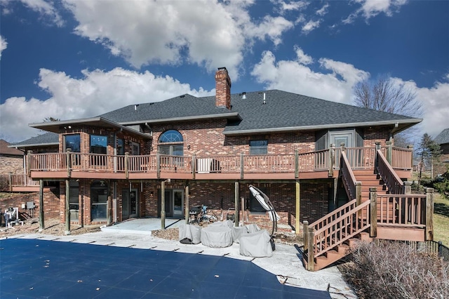 rear view of house with a patio area, stairs, a deck, and brick siding