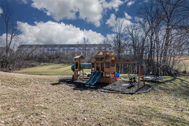 view of jungle gym with a trampoline and a lawn