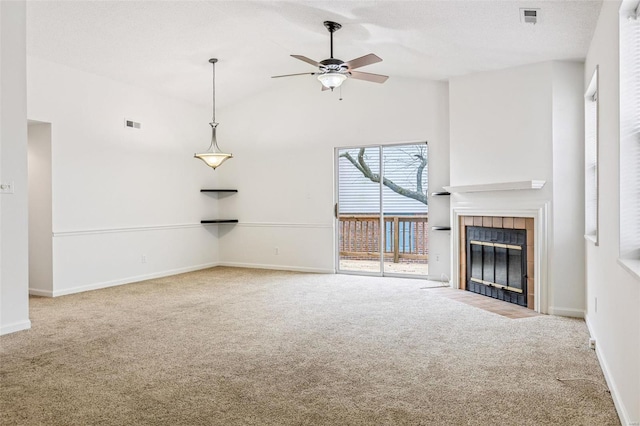 unfurnished living room featuring carpet floors, vaulted ceiling, and a tiled fireplace