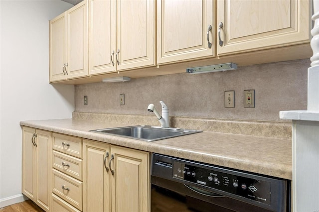 kitchen featuring cream cabinetry, light countertops, backsplash, a sink, and dishwasher