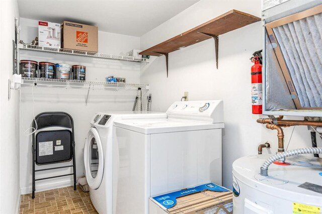 washroom featuring washer and dryer, laundry area, and water heater