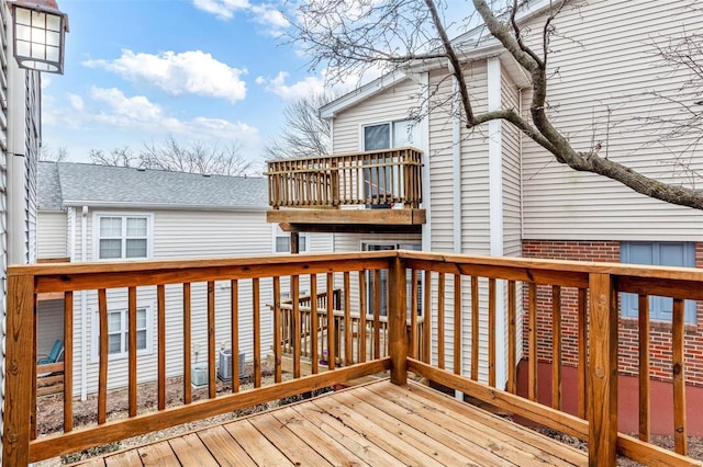 wooden deck featuring cooling unit