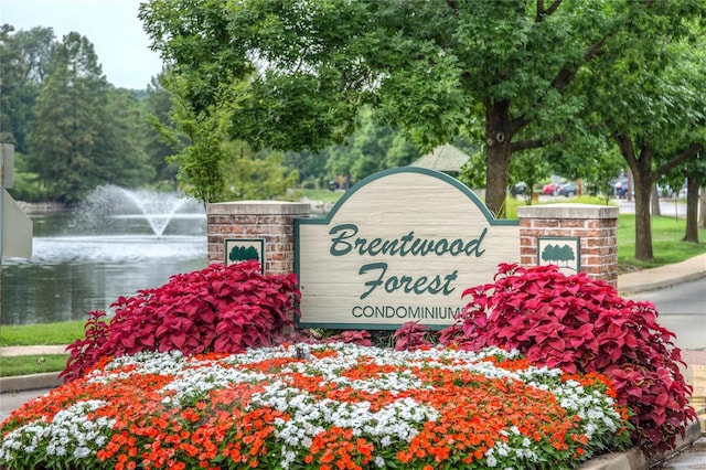 community / neighborhood sign with a water view