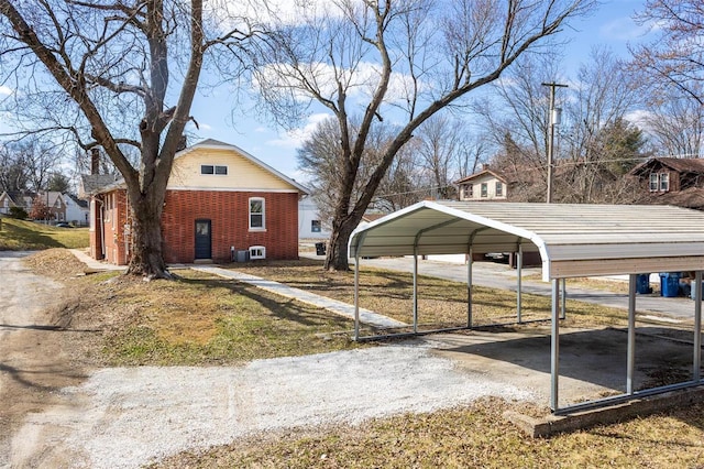 view of home's exterior featuring a detached carport and brick siding