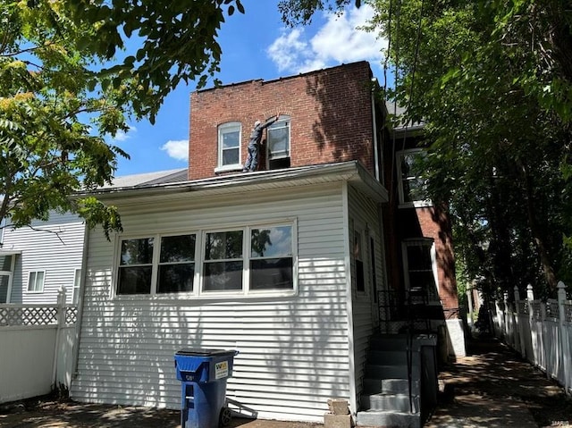 rear view of house with fence