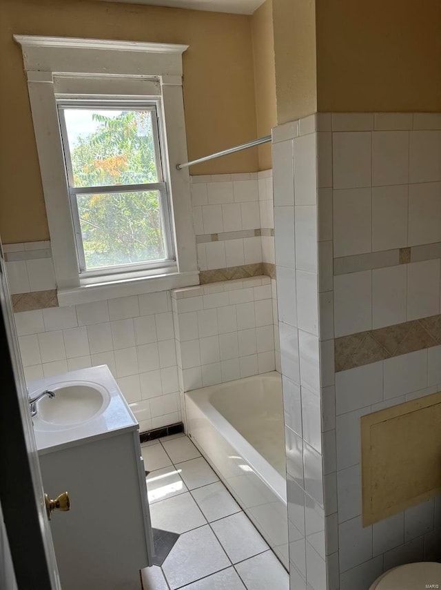 bathroom with wainscoting, vanity, tile walls, and tile patterned floors