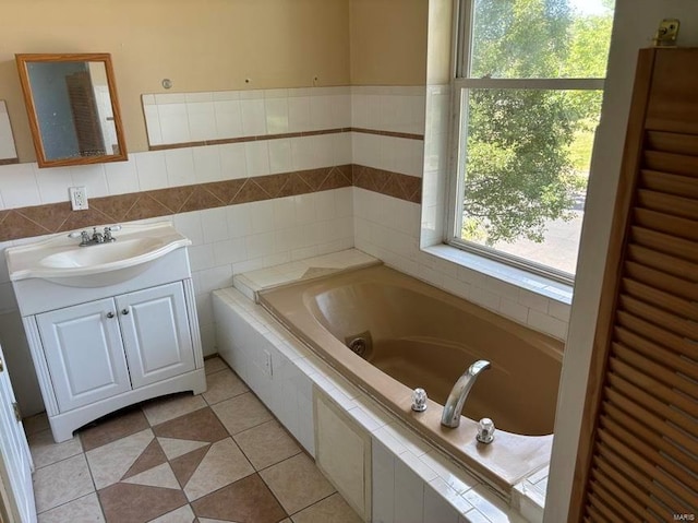 full bathroom featuring plenty of natural light, vanity, a bath, and tile walls