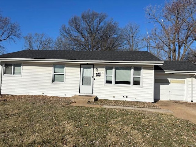 single story home with concrete driveway, an attached garage, and a front yard