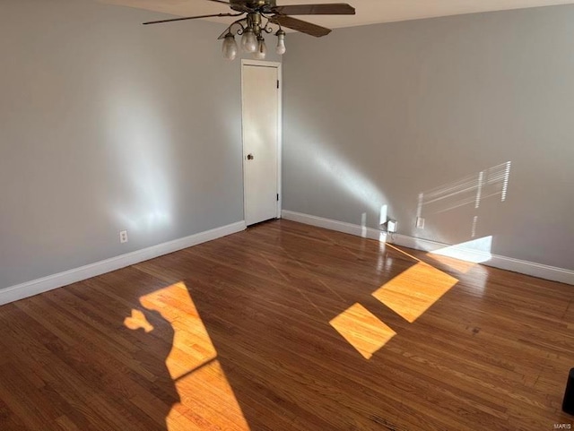 unfurnished room with ceiling fan, baseboards, and wood finished floors