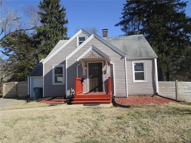 view of front of property with a front lawn, a gate, fence, and a chimney