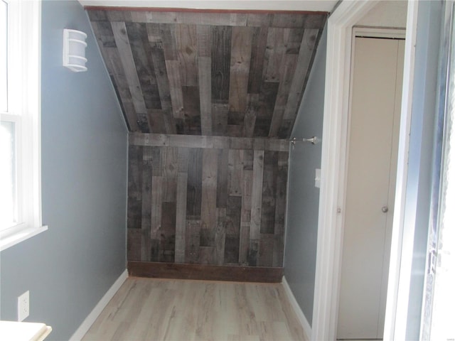 bathroom featuring vaulted ceiling, wood ceiling, baseboards, and wood finished floors