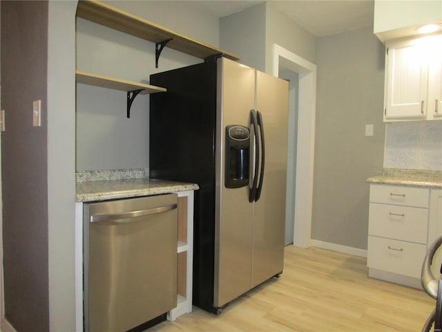 kitchen with open shelves, white cabinetry, stainless steel appliances, light wood finished floors, and baseboards