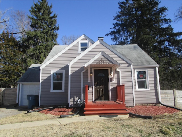 view of front facade featuring a chimney, a shingled roof, an attached garage, and fence