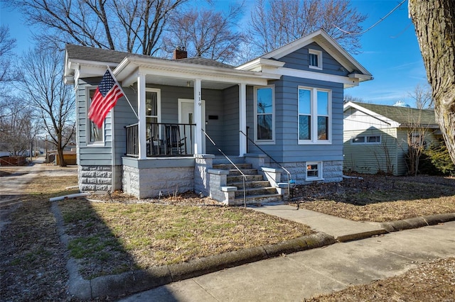 bungalow-style home featuring a porch and a chimney