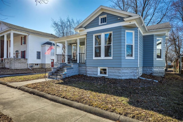 view of front of house featuring a porch and roof with shingles