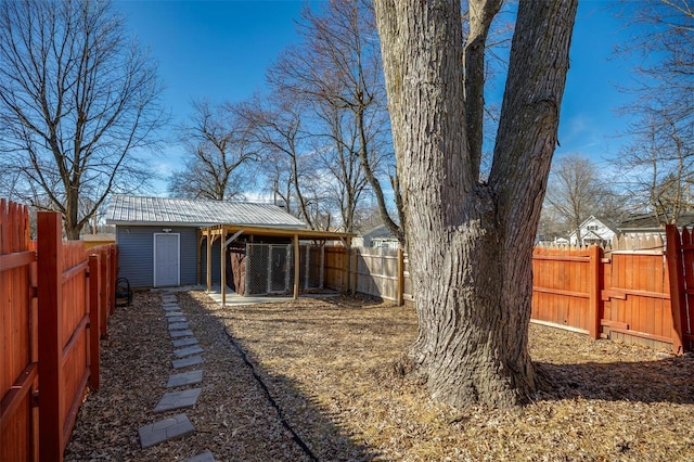 view of yard featuring an outbuilding and a fenced backyard