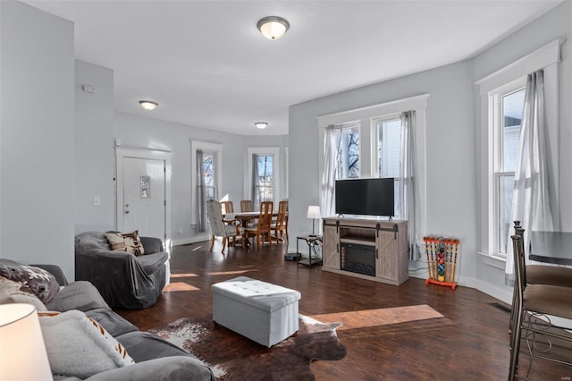 living area featuring wood finished floors, a wealth of natural light, and baseboards