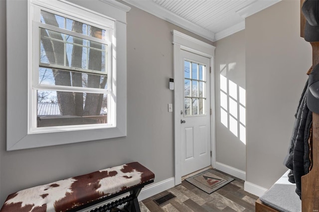 foyer with ornamental molding, dark wood-style flooring, visible vents, and plenty of natural light