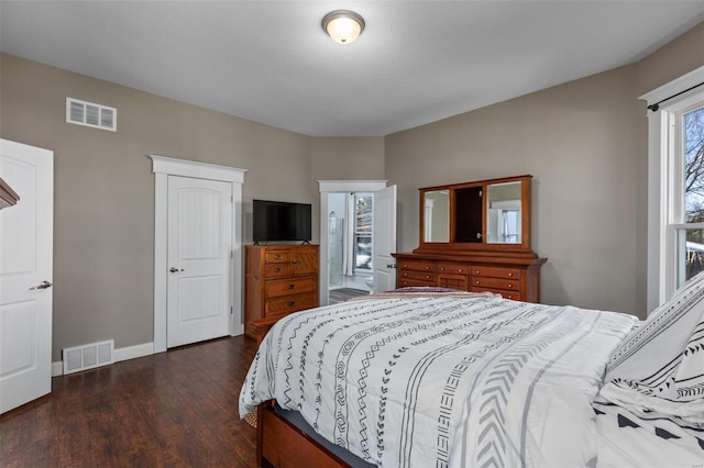 bedroom with baseboards, visible vents, and dark wood-style flooring