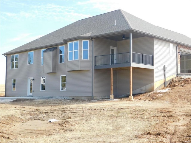 back of property featuring a shingled roof