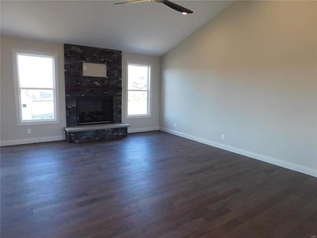 unfurnished living room featuring ceiling fan, a large fireplace, baseboards, vaulted ceiling, and dark wood-style floors