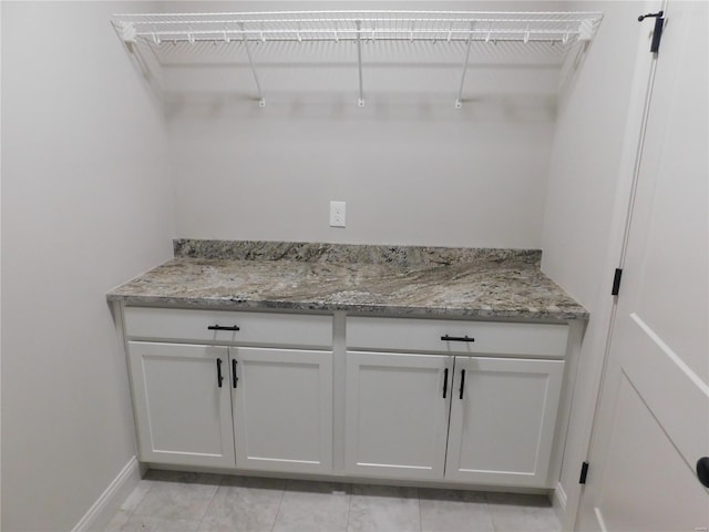 laundry room featuring baseboards