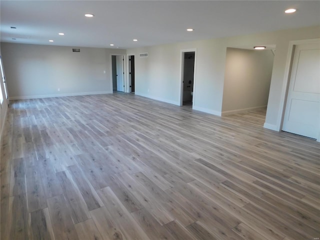 spare room featuring recessed lighting, visible vents, baseboards, and wood finished floors