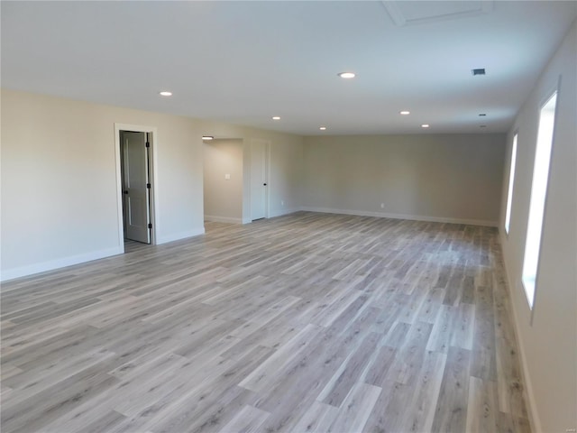 spare room featuring baseboards, recessed lighting, and light wood-style floors