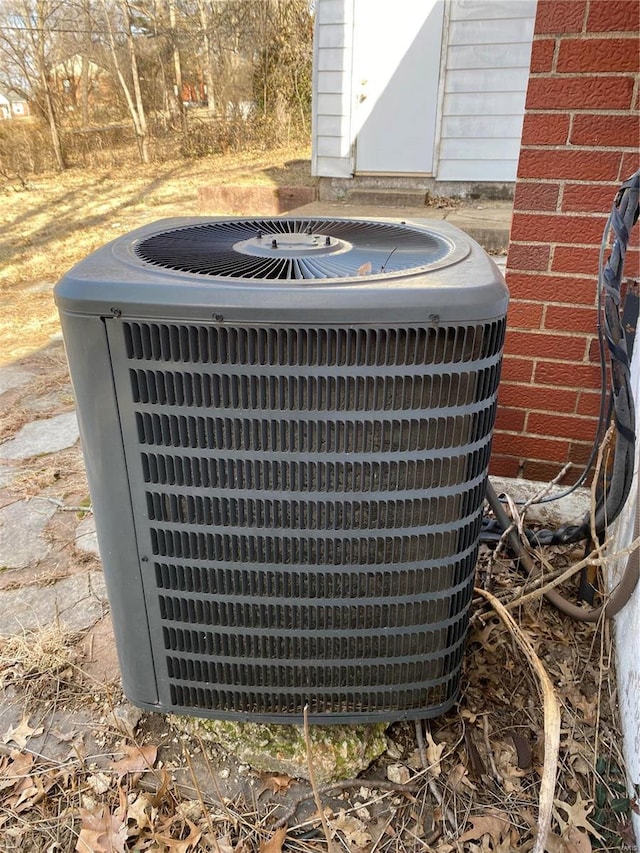 exterior details with brick siding and central air condition unit