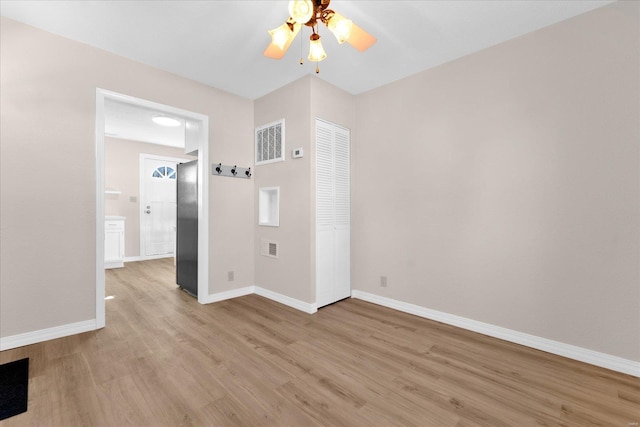 unfurnished bedroom featuring a closet, light wood-type flooring, visible vents, and baseboards