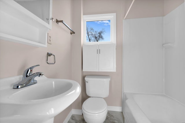 full bath featuring toilet, washtub / shower combination, baseboards, and a sink