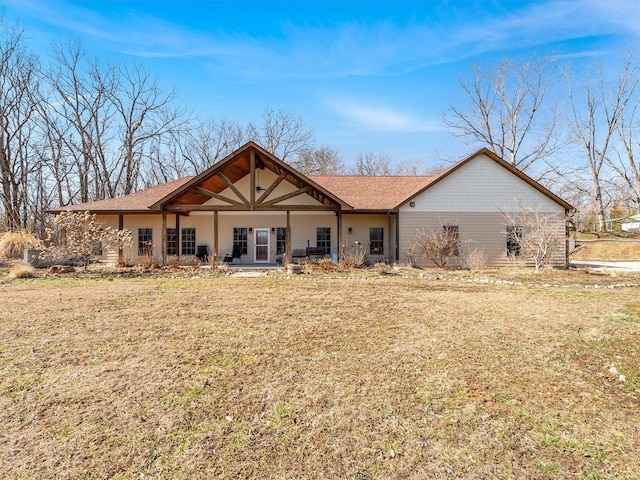 back of property featuring a lawn