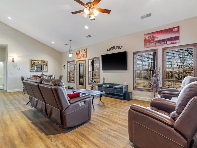 living area featuring baseboards, light wood finished floors, visible vents, and a ceiling fan