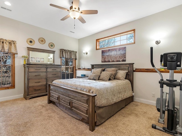 bedroom with light colored carpet, visible vents, and baseboards