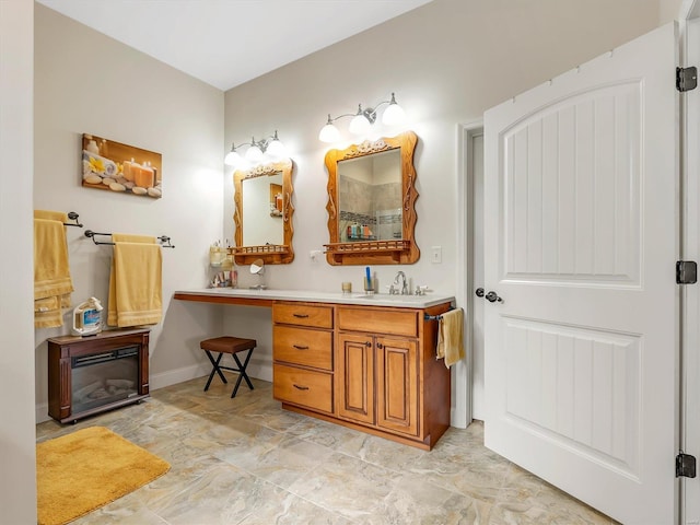 full bath featuring baseboards and vanity