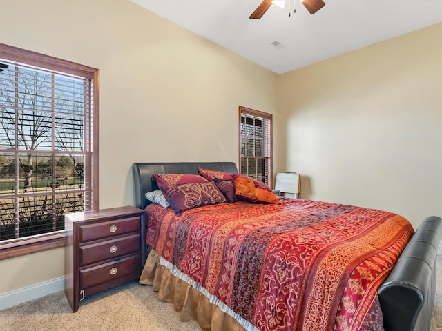 bedroom with carpet floors, visible vents, baseboards, and a ceiling fan