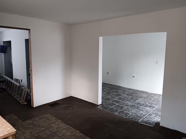 unfurnished room with visible vents