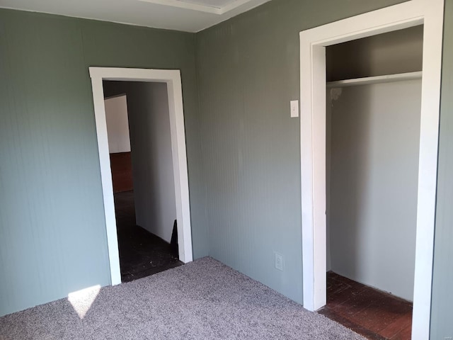 unfurnished bedroom with a closet and carpet