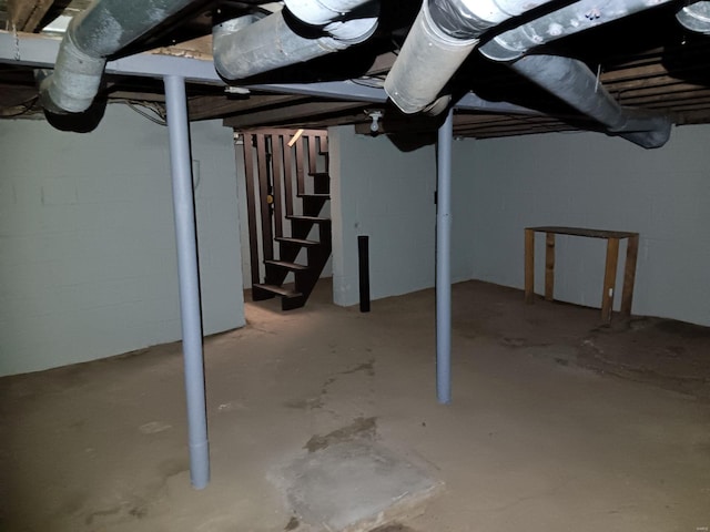 unfinished basement featuring stairway