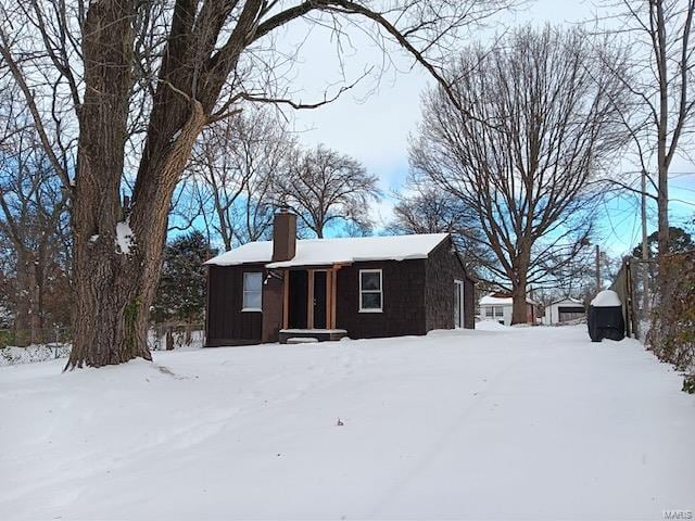 view of front of property with a garage and a chimney