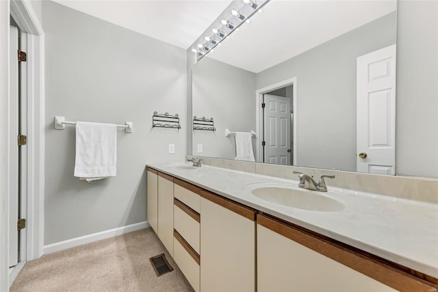 full bathroom with double vanity, baseboards, visible vents, and a sink