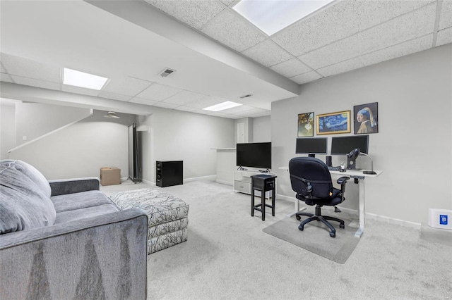 carpeted office space with visible vents, baseboards, and a drop ceiling