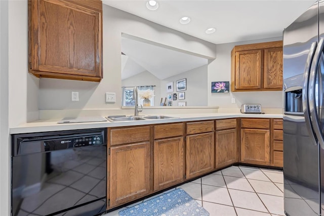 kitchen featuring black dishwasher, brown cabinetry, light countertops, stainless steel refrigerator with ice dispenser, and a sink